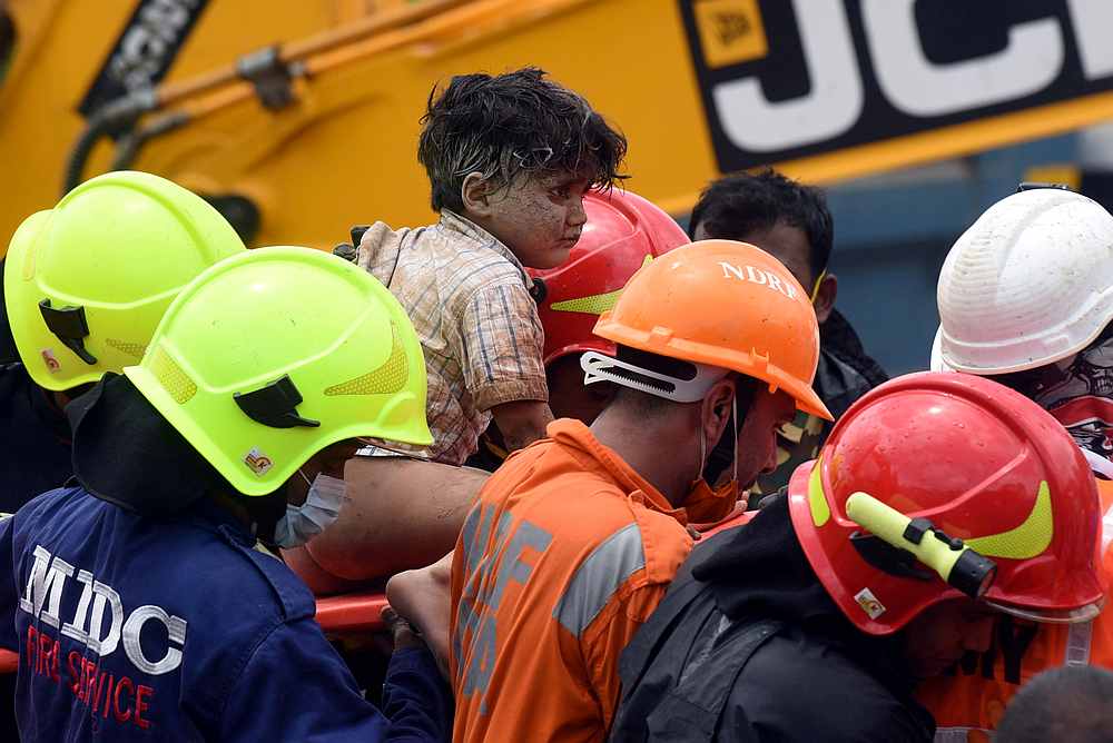 Rescue workers carry Mohammed Bangi, a four-year-old boy, after he was rescued from the rubble at the site of a collapsed building in Mahad, Raigad district, Maharashtra, India August 25, 2020. u00e2u20acu201d Reuters pic