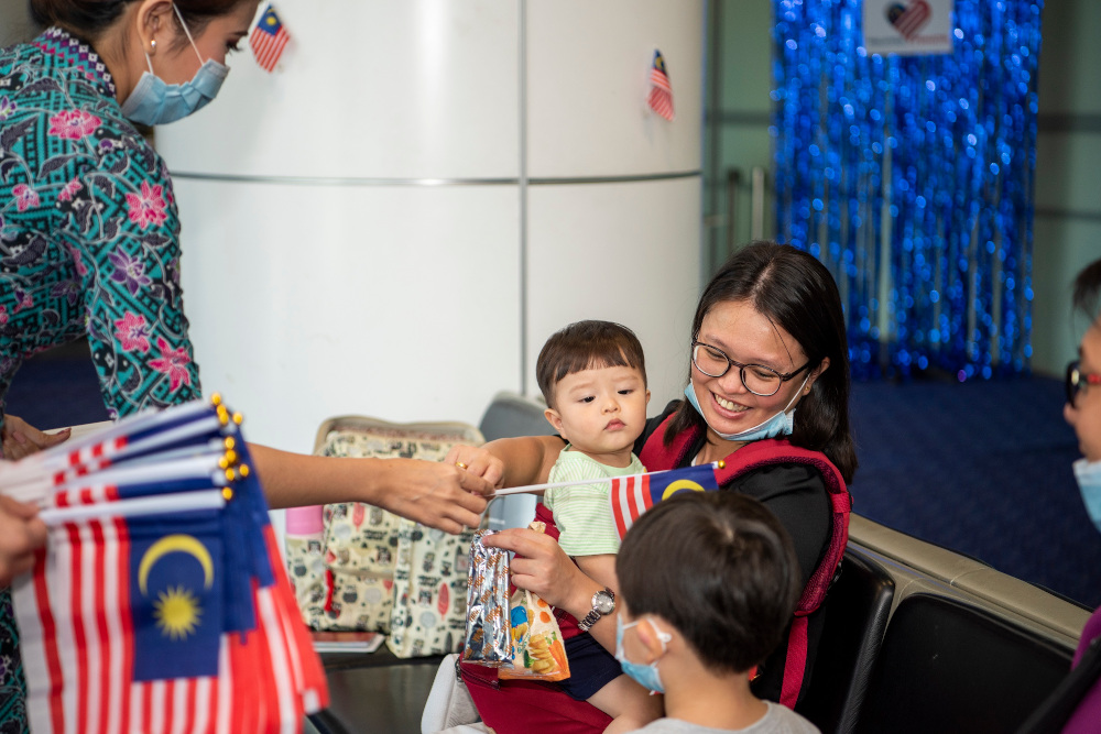 Malaysia Airlines staff distribute the u00e2u20acu02dcJalur Gemilangu00e2u20acu2122 flags to passengers travelling with the airlines, August 31, 2020. u00e2u20acu201d Picture courtesy of Malaysia Airlines Berhad 