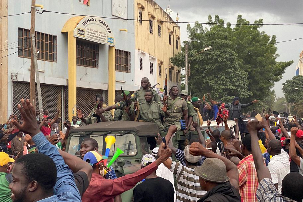 Malian soldiers are celebrated as they arrive at the Independence square in Bamako August 18, 2020. u00e2u20acu201d AFP pic 