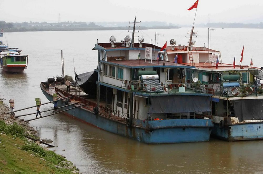 Workers load a Chinese boat at a Thai Mekong river port in the Golden Triangle region, where the borders of Thailand, Laos and Myanmar meet. u00e2u20acu201d Reuters file pic