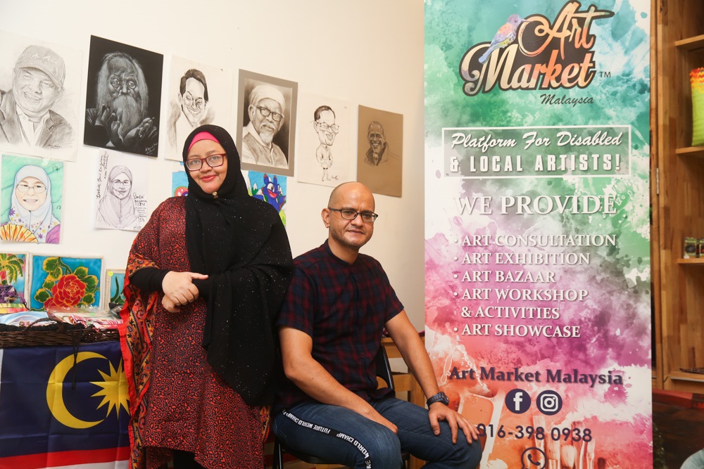 Hazrita Mohd Hatta (Founder of Art Market Malaysia Gallery) and her husband Mohamed Hussien Mohamed Ahmed at the Merdeka Art Exhibition at Quill City Mall, Kuala Lumpur. u00e2u20acu2022 Picture by Choo Choy May