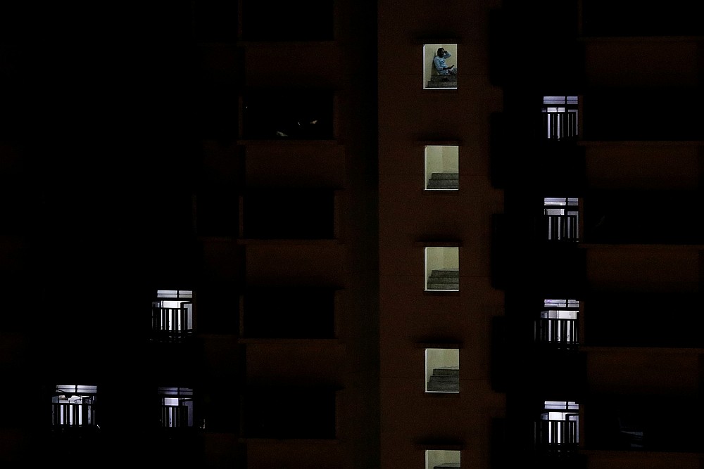 A migrant worker sits outside his room in a dormitory amid the Covid-19 outbreak in Singapore April 30, 2020. u00e2u20acu201d Reuters pic