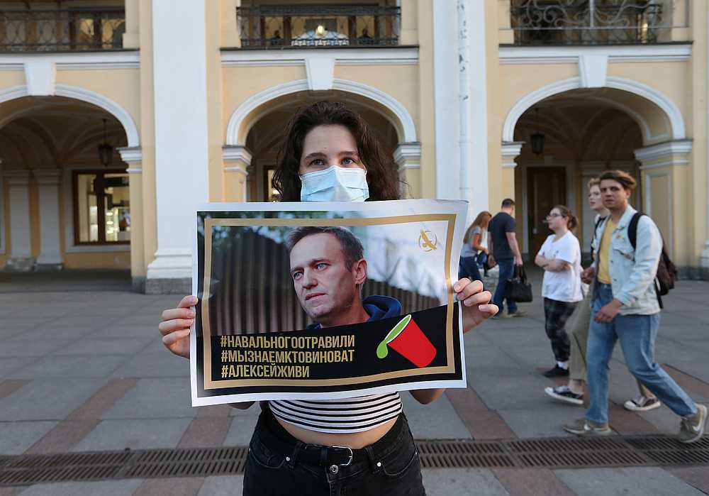 A woman at a gathering to show support for Russian opposition leader Alexei Navalny, in Saint Petersburg, Russia August 20, 2020. The placard reads 'Navalny was poisoned. We know who is to blame. Alexei, live.' u00e2u20acu201d Reuters pic