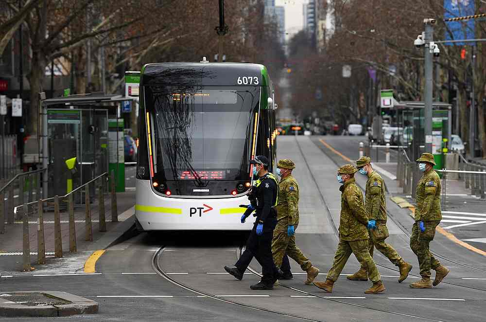 Victorian Police officers and ADF patrol Bourke street as the city operates under lockdown to curb the spread of Covid-19 in Melbourne, Australia August 7, 2020. u00e2u20acu201d AAP Image via Reuters