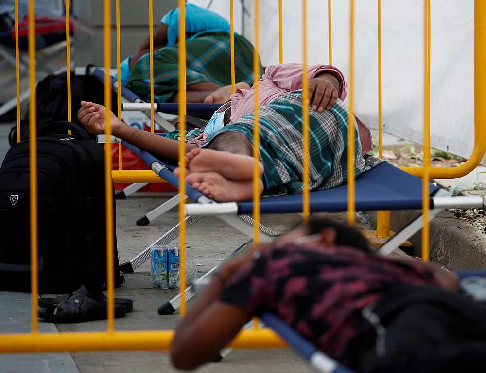 Migrant workers rest at a swab isolation facility as they wait for their test results at a dormitory, amid the Covid-19 outbreak in Singapore May 15, 2020. u00e2u20acu201d Reuters pic