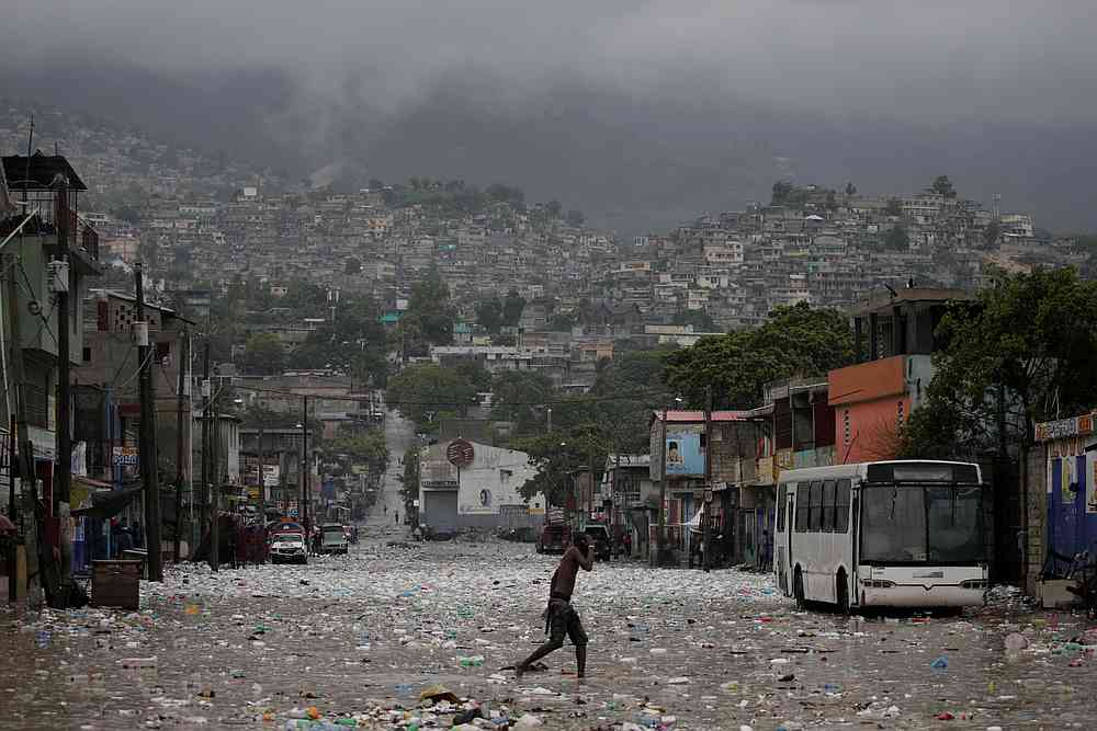 A man walks in a flooded street during the passage of Tropical Storm Laura, in Port-au-Prince, Haiti August 23, 2020. u00e2u20acu201d Reuters pic 