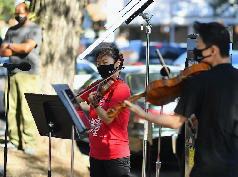 Violinist Quan Ge (left) and violist Cong Wu of the New York Philharmonic play with their 'bandwagon's pop-up concert series' at Betty Carter Park in Brooklyn September 4, 2020. u00e2u20acu201d AFP pic