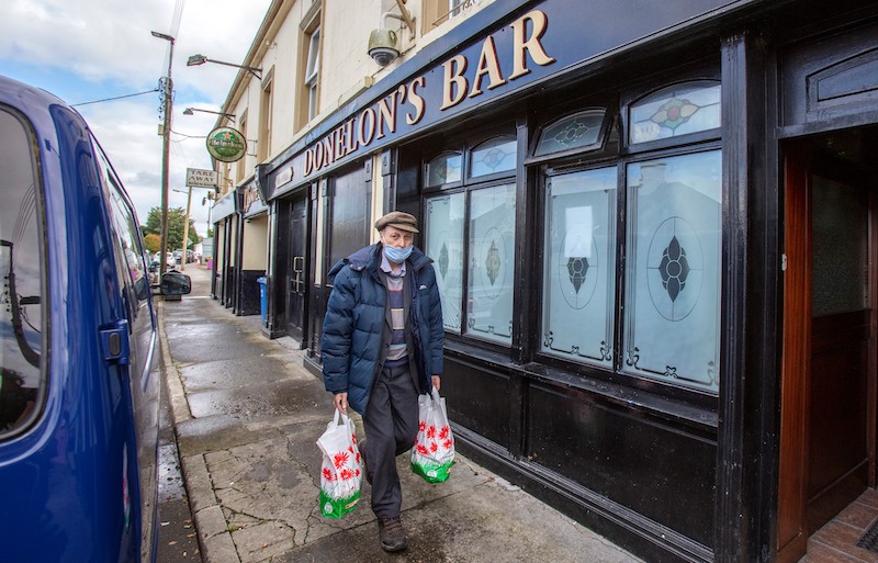 A man wearing a face mask or covering due to the Covid-19 pandemic, walks past the closed Donelonu00e2u20acu2122s Bar in the rural village of Dunmore, Ireland September 3, 2020. u00e2u20acu201d AFP pic