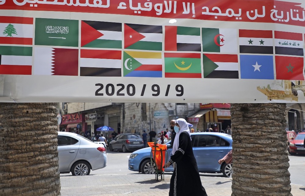 A banner showing the flags of Arab countries and reading u00e2u20acu02dcHistory will only glorify those loyal to Palestineu00e2u20acu2122 is seen during a rally against the UAE-Israel normalisation deal in the occupied West Bank city of Nablus on September 9, 2020, as Arab forei