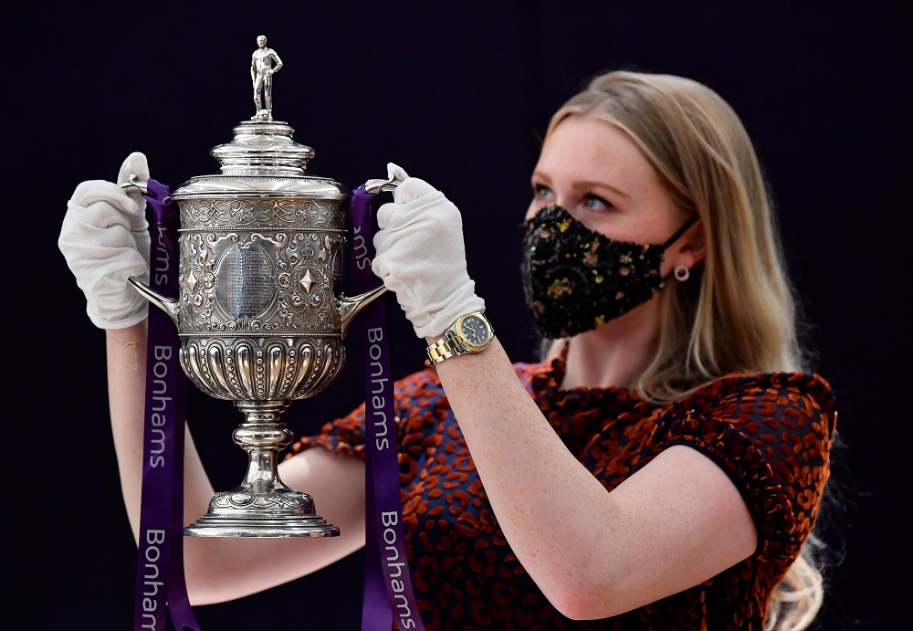 Laurel Kemp, Cataloguer at Bonhams, holds the FA Cup 1896-1910 ahead of a forthcoming auction of Spectacular Sporting Trophies and Memorabilia, in London September 7, 2020. u00e2u20acu201d Reuters pic