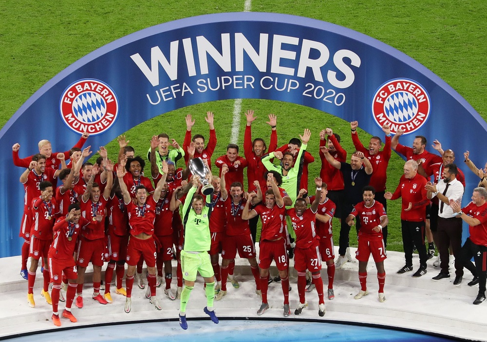Bayern Munich's Manuel Neuer celebrates with the trophy and teammates after winning the European Super Cup at the Puskas Arena in Budapest September 24, 2020. u00e2u20acu201d Picture by Pool via Reuters