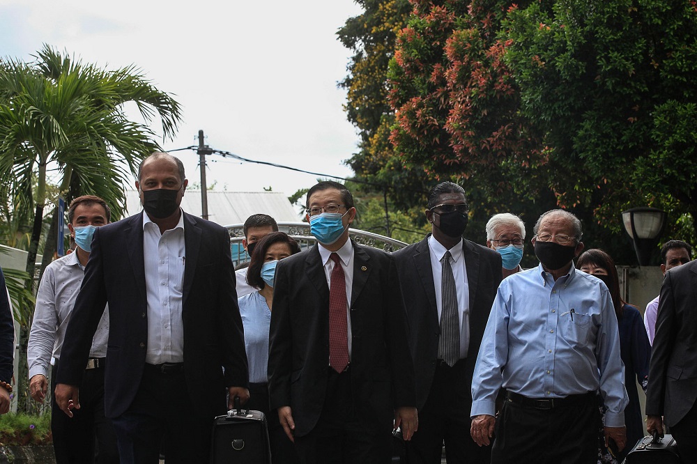 Former Penang chief minister Lim Guan Eng (centre) and his lawyer Gobind Singh Deo (second left) arrive at the Butterworth Sessions Court September 11, 2020. 