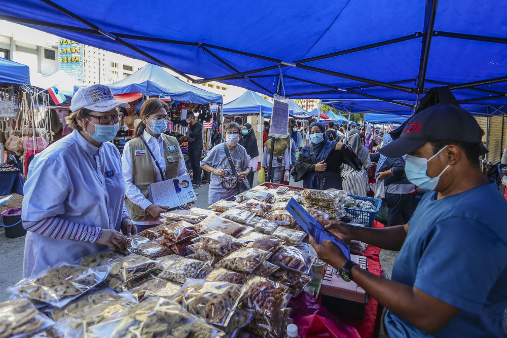 PKR party candidate for the Api-Api constituency Sabah PKR chairman Datuk Christina Liew (left) during a walkabout at the Gaya Street (Sunday Market) in Kota Kinabalu, Sabah September 13, 2020. — Picture by Firdaus Latif