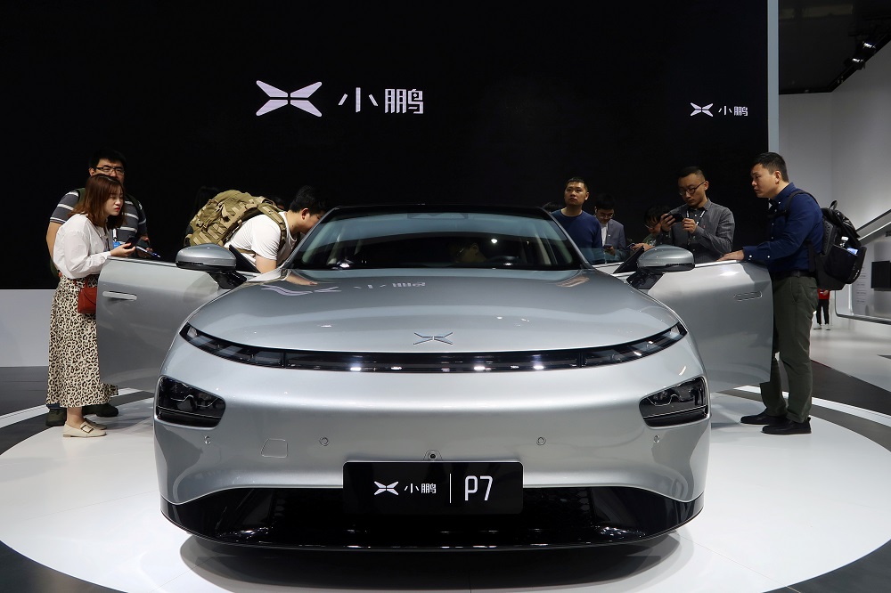 People look at XPeng's P7 sedan model displayed at the Guangzhou auto show in Guangzhou, Guangdong province, China November 22, 2019. u00e2u20acu2022 Reuters file pic
