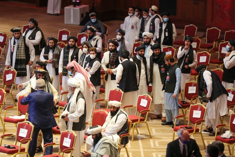Members of the Taliban delegation leave their seats at the end of the session during the peace talks between the Afghan government and the Taliban in the Qatari capital Doha on September 12, 2020. — AFP pic