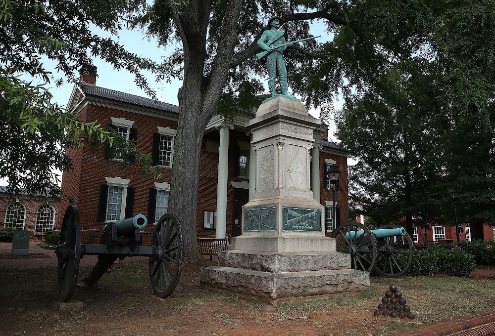 In this file photo taken on August 22, 2017, the u00e2u20acu02dcAt Readyu00e2u20acu2122 statue of a Confederate soldier and two Civil War cannons stand in front of the Albemarle County Court House on in Charlottesville, Virginia. u00e2u20acu201d AFP picnn
