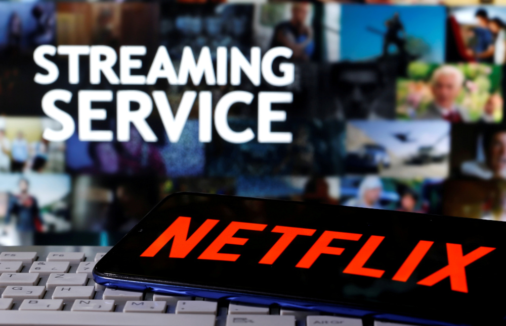 A smartphone with the Netflix logo is seen on a keyboard in front of displayed u00e2u20acu02dcStreaming serviceu00e2u20acu2122 words in this illustration taken March 24, 2020. u00e2u20acu201d Reuters pic 
