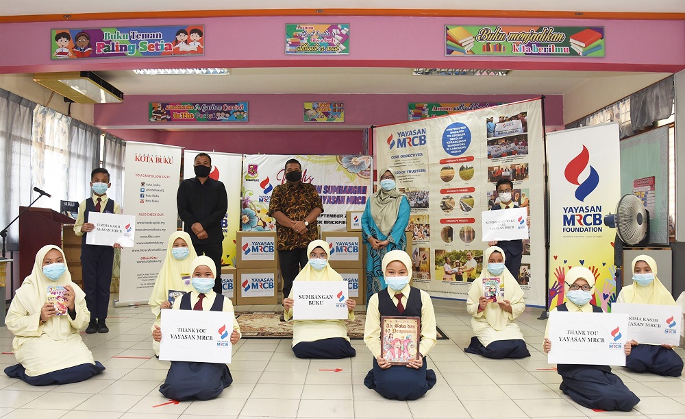 Students and their collection of books that were donated by Yayasan MRCB. u00e2u20acu201d Picture courtesy of Yayasan MRCB