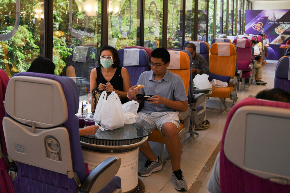 Customers eat at Thai Airways pop-up airplane-themed restaurant at the airlines headquarters with onboard meals prepared by their chefs in Bangkok, Thailand September 3, 2020. u00e2u20acu201d Reuters pic 