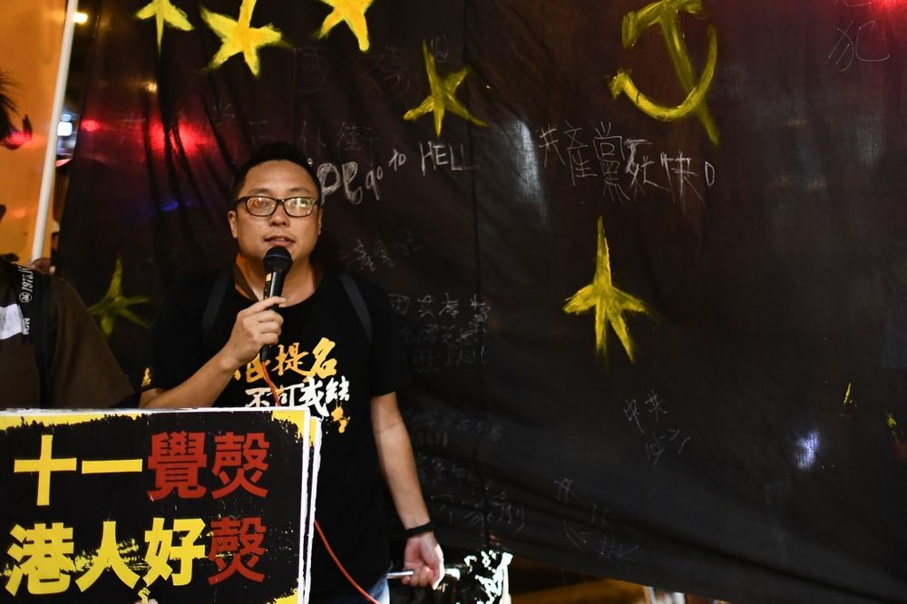 Activist Tam Tak-chi walks with a black banner towards the Chinese Liaison office after an annual protest march on Chinau00e2u20acu2122s national day, in Hong Kong in this file photo taken on October 1, 2017. u00e2u20acu201d AFP pic