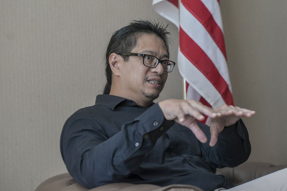 Election Commission deputy chairman Azmi Sharom talks about the challenges of having a sudden surge in the number of voters after the automatic voter registration is sorted out. — Picture by Shafwan Zaidon