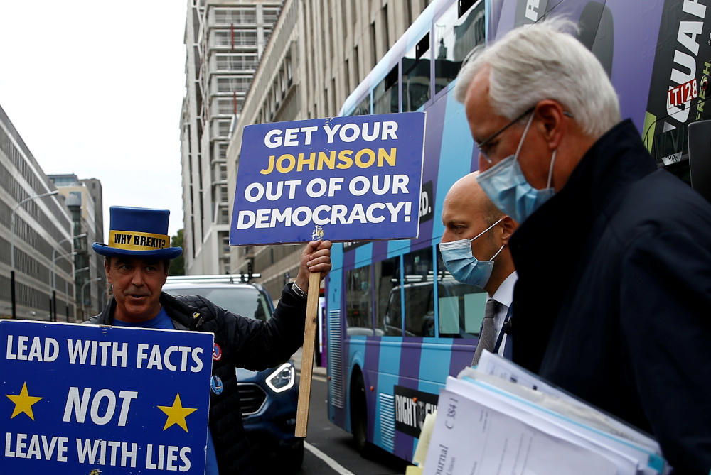 Anti-Brexit demonstrator Steve Bray holds placards as EUu00e2u20acu2122s Chief Negotiator Michel Barnier walks with an entourage to a meeting in Westminster, London, Britain September 9, 2020. u00e2u20acu201d Reuters pic 