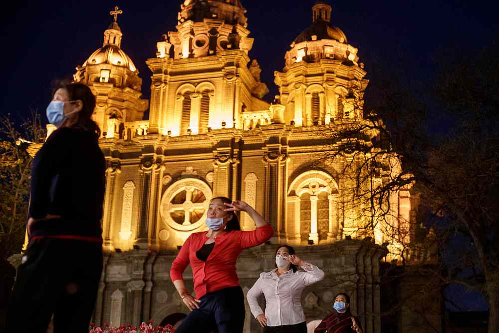 Women take part in a square dance routine in front of St Joseph's Catholic Church in Beijing, China April 12, 2020. u00e2u20acu201d Reuters pic