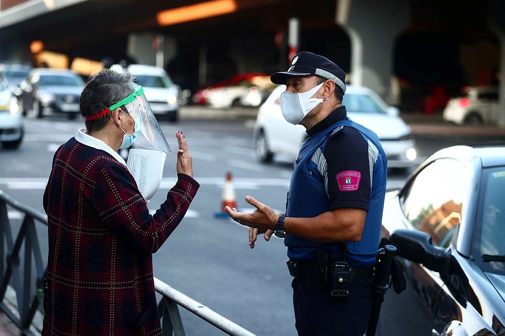 A local police officer speaks with a woman in the Vallecas neighbourhood during the first day of a partial lockdown amid the outbreak of Covid-19 in Madrid, Spain September 21, 2020. u00e2u20acu201d Reuters pic