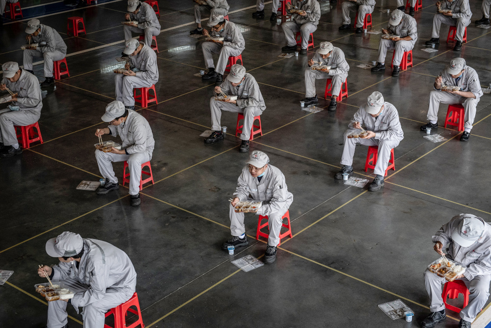 This file photograph taken March 23, 2020 shows employees eating during lunch break at an auto plant of Dongfeng Honda in Wuhan in Chinau00e2u20acu2122s central Hubei province. u00e2u20acu201d AFP pic 