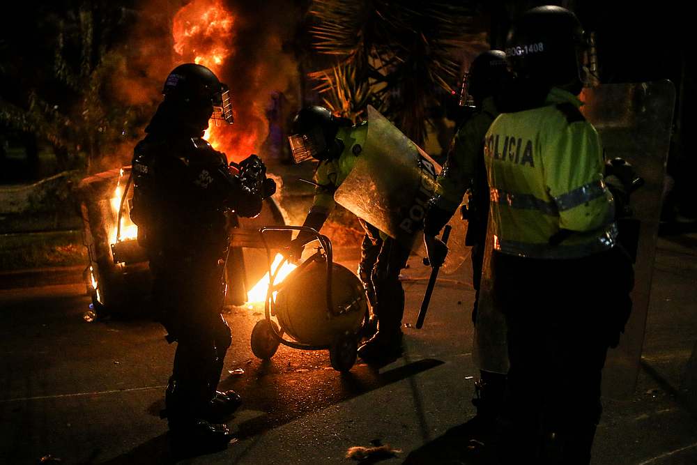 Police officers attempt to extinguish fire from a burning dumpster during a protest in Bogota, Colombia September 10, 2020. u00e2u20acu201d Reuters pic