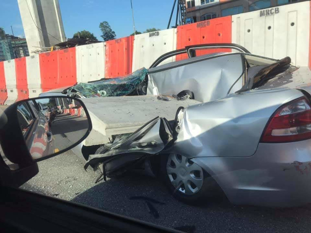 A woman escaped with just an injured left hand when a concrete slab from the construction of the Sungai Besi-Ulu Klang Elevated Expressway (SUKE) fell and hit her car September 19, 2020. u00e2u20acu201d Picture via Twitter/Bernama