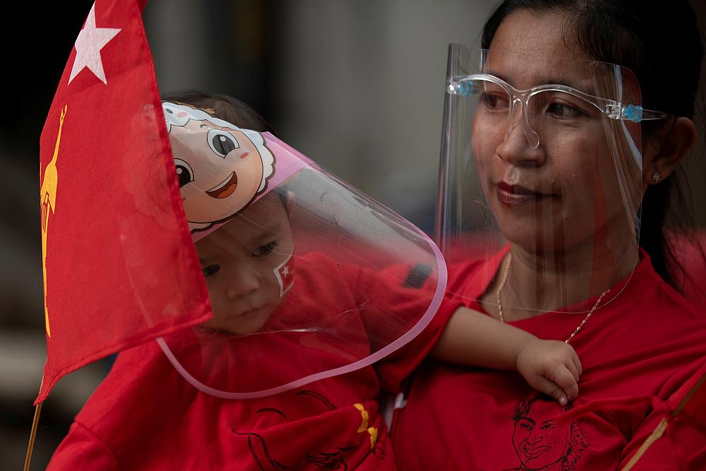 A mother and her son hold a flag of National League for Democracy (NLD) party, amid Covid-19 concerns during an election campaign rally in Yangon, Myanmar September 8, 2020. u00e2u20acu201d Reuters pic