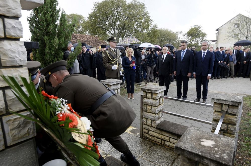 Croatian Prime Minister Andrej Plenkovic (second right), stands to attention as a wreath is laid in commemoration of ethnic Serb civilians killed in the aftermath of the countryu00e2u20acu2122s 1990s independence war, in Varivode, southern Croatia, September 28, 2020