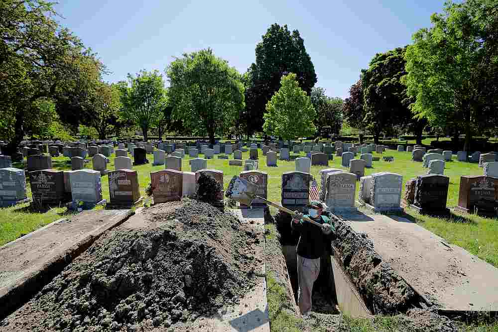 Roberto Arias prepares a grave for burial at Woodlawn Cemetery during the Covid-19 outbreak in Everett, Massachusetts May 27, 2020. u00e2u20acu201d Reuters pic