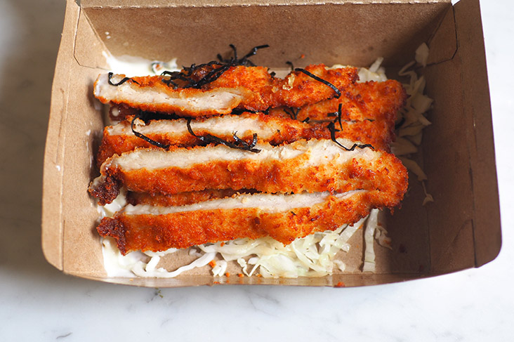 The Japanese pork cutlet is all cut up and served with mayonnaise and cabbage