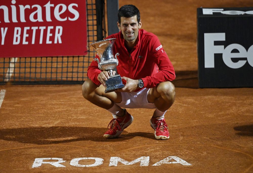 Serbia's Novak Djokovic celebrates with the Italian Open trophy after winning the final against Argentina's Diego Schwartzman September 21, 2020. u00e2u20acu201d Reuters picn