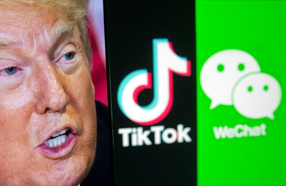 A picture of US President Donald Trump is seen on a smartphone in front of displayed TikTok and WeChat logos in this illustration taken September 18, 2020. u00e2u20acu201d Reuters pic