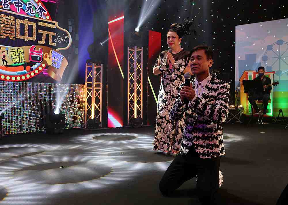 Getai veterans Wang Lei and Liu Ling Ling (left) offer prayers at an altar before a live streaming getai show at a studio in Singapore September 5, 2020. u00e2u20acu201d Reuters pic
