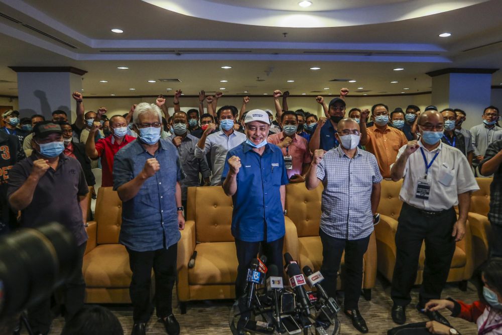 Sabah Bersatu chief Datuk Hajiji Noor (centre) poses for a group photo with Gabungan Rakyat Sabah leaders during a press conference at the Magellan Sutera Resort in Kota Kinabalu September 26, 2020. u00e2u20acu201d Picture by Firdaus Latif