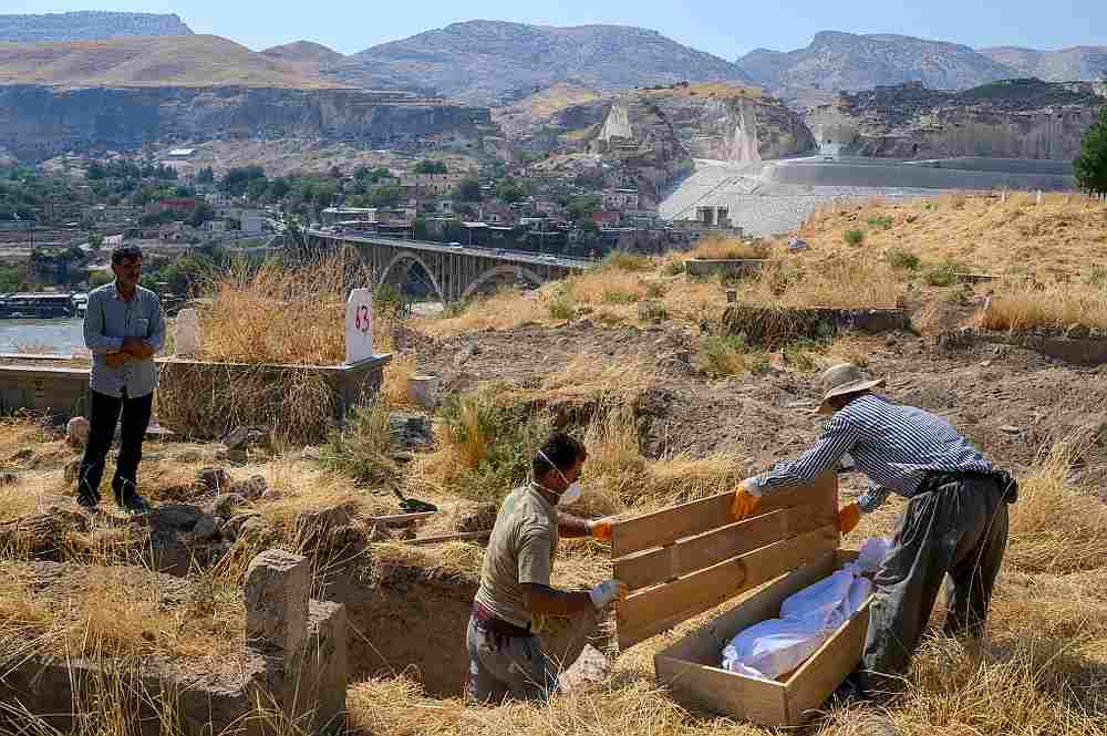 Cetin Cile, watches his mothers' body being romoved from the old Hasankeyf cemetery to the new one, on the banks of the Tigris in southeastern Turkey September 15, 2019. u00e2u20acu201d AFP pic