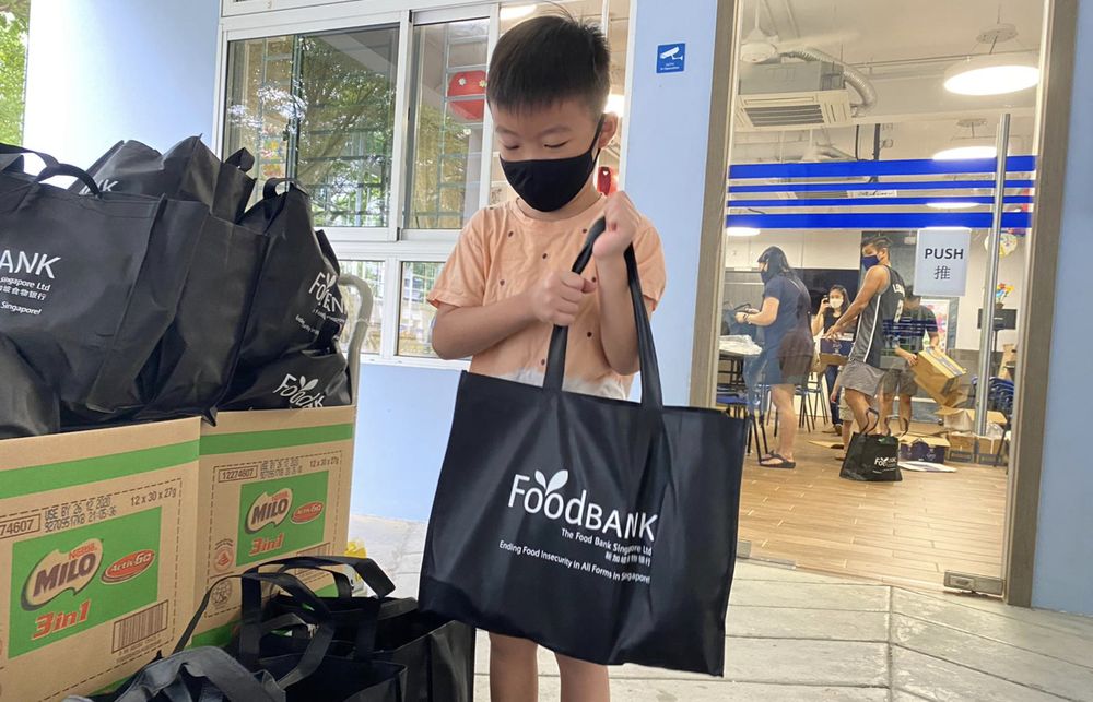 A boy helping to sort donated items at The Food Bank Singapore. — The Food Bank Singapore/Facebook/TODAY pic