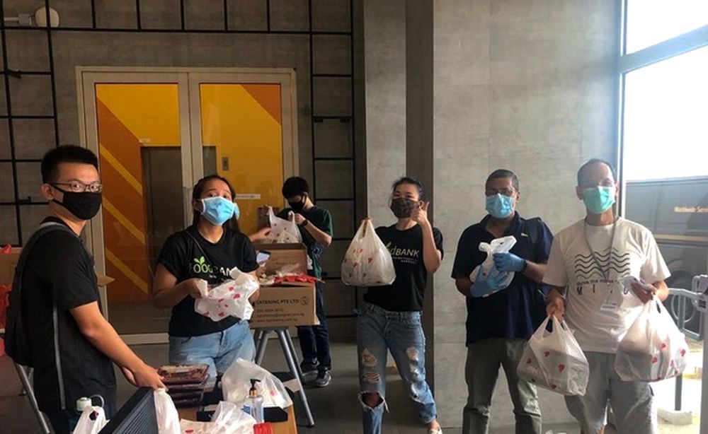 Volunteers and a worker from The Food Bank Singapore packing food items. — The Food Bank Singapore/TODAY pic