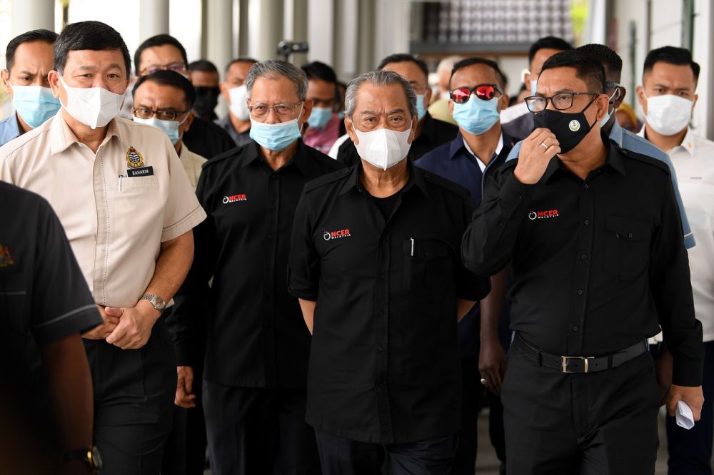 Prime Minister Tan Sri Muhyiddin Yassin (centre) is pictured with Perak Mentri Besar Datuk Seri Ahmad Faizal Azumu during a working visit to the Pangkor Jetty September 15, 2020. u00e2u20acu201d Bernama pic