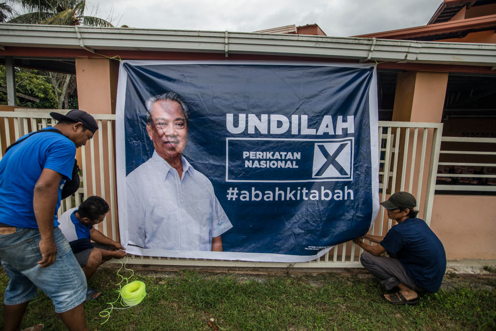 An election poster featuring Perikatan Nasional chairman Tan Sri Muhyiddin Yassin is seen in Kota Belud, Sabah September 16, 2020. — Picture by Firdaus Latif