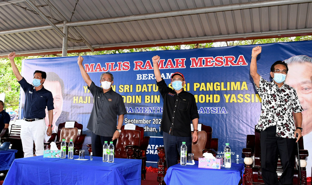 Prime Minister Tan Sri Muhyiddin Yassin with Agriculture and Food Industries Minister Datuk Seri Ronald Kiandee (second, right) and former Sabah chief minister Tan Sri Musa Aman (right) during a meet and greet programme at Tapak Tamu Pekan Kuala Penyu, Se
