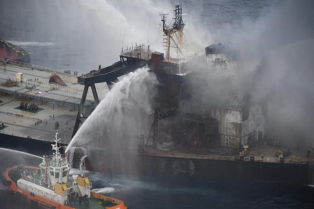 A Sri Lankan Navy boat sprays water on oil tanker New Diamond after a fire broke out off the east coast of Sri Lanka September 8, 2020. u00e2u20acu201d Sri Lankan Airforce handout via Reuters