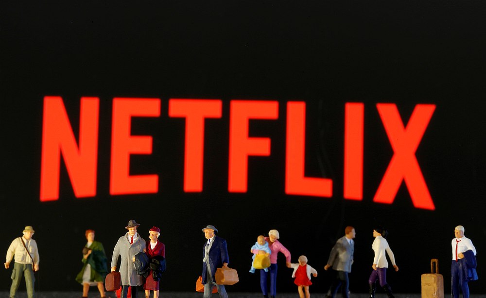 Small toy figures are seen in front of diplayed Netflix logo in this illustration taken March 19, 2020. u00e2u20acu201d Reuters pic