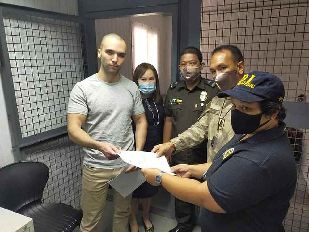US Marine Joseph Scott Pemberton (left) with his lawyer and prison officials during his turnover to the Bureau of Immigration in Quezon City, Philippines September 11, 2020. u00e2u20acu201d Philippines Bureau of Corrections handout via Reuters