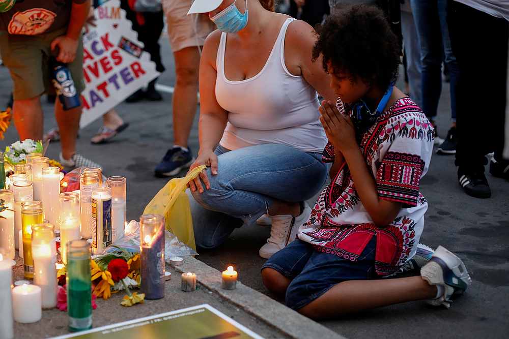 Demonstrators kneel in front of a memorial during a protest following the death of a Black man, Daniel Prude, during an arrest on March 23, in Rochester, New York September 3, 2020. u00e2u20acu201d Reuters pic