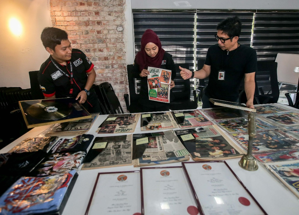 PORT Ipoh general manager Nur Hanim Mohamed Khairuddin (centre), manager Syed Zarul Hisham Syed Khairuddin (right) and PR officer Mohamad Huzaifah Abd Aziz with some items to be exhibited during the Ipoh Music Symposium. u00e2u20acu201d Picture by Farhan Najib